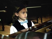 Sebastian “Bash” Ore plays the piano to raise funds to help his grandfathers.