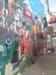 Chappaqua artist Sophie Mendelson worked on the new mural this summer on the wall of the building that houses Hall of Scoops.