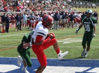 Crusaders wide receiver T. J. Morrison (center) tucks the ball after catching a pass from Brendon Coleman in the end zone for Stepinac’s second touchdown of the game. 