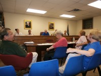 Democratic Commissioner Cathy Croft (center, in blue chair) and Republican Commissioner Tony Scannapieco (left) discussed the Board of Elections taking over Cold Spring’s election next year. 