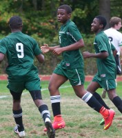 Nile Williams (8) get congrats from teammates after scoring against Croton.