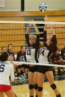 Dominigue Loguidice (13) and Jade Pineda (14) of Harrison set up at the net.