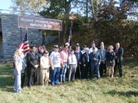 State Sen. Greg Ball and State Assemblyman Sandy Galef, along with other local and state officials and plenty of veterans stand underneath the new sign for the Disabled American Veterans Bridge. 