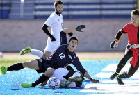 The Bobcats' Brandon Drossman is sent to the turf by a sliding tackle late in Saturday's state semifinal playoff game vs. Greece Athena.