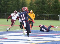 Stepinac’s wide receiver Andrew Geni (right) beats Lions defensive back Justin Clark (left) to the end zone and grabs an 11-yard touchdown pass, as his teammate Jesse Brown (center) comes to celebrate. Albert Coqueran Photos