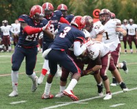 Stepinac’s Demarcus Miller (#3 center) tackles Lions running back Steven Viegas. Miller leads the Crusaders in tackles with 27, while his defense has only relinquished 83 points to opponents in nine games this season. 