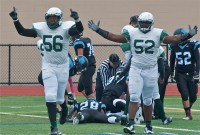 Omar DeBerry (56) and Dondi Crawford (52) celebrate forced fumble, recovered by Woodlands.