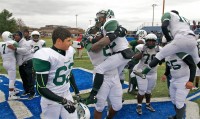 Woodlands players and coaches celebrate at the final whistle Saturday.