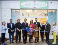 Members of the Mount Kisco Chamber of Commerce and Assemblyman David Buchwald surround  Ayo Hart, her husband, Nigel, and their two children, Madison & Victoria, at the recent ribbon cutting for Hart's business, Expect Natural. Jennifer McKenna Photography 