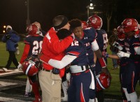 Crusaders Offensive Coordinator Joe Spagnolo hugs his two quarterbacks Brandon Coleman and Tyquell Fields after Stepinac won the CHSFL AAA Championship for the first time since 1955. 