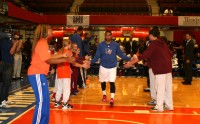 Guard Andre Barrett is greeted by students from Good Counsel Academy Elementary School, as the Westchester Knicks starting line-up is announced during pregame festivities on “School Day” at the Westchester County Center. 