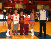 Francesca De lia (center) and Carys Daly (third right) from Good Counsel Academy Elementary School participated in the ball transfer ceremony during pregame festivities, before the Westchester Knicks played the Erie Bayhawks, on “School Day” at the Westchester County Center, on Wednesday, Dec.3. Photo by Albert Coqueran 