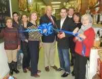 Hudson Valley Olive Oil owner Shane Furnia cuts the ribbon at his store's Dec. 6 grand opening with help from Mount Kisco Mayor Michael Cindrich and village Trustee Jane Farber.