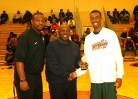 [L-r] White Plains Assistant Coach Davon Wilson and tournament namesake, Harry Jefferson present the MVP of the Game Award to Woodlands' forward Jamil Gambari, who scored 27 points for the Falcons in their, 72-53 win over White Plains.