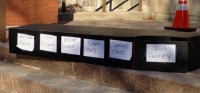 A mock coffin was laid on the steps of Police Headquarters.