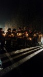 Pleasantville firefighters and members of the White Plains DPW hold candles during Monday's vigil for former colleague Tom Dorr, who was murdered 19 years ago last week.