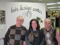 Photo caption: Osvaldo Benigni, left, and his brother Luigi have co-owned and worked at Hair Design Center in the Underhill Plaza shopping center for 38 years. Also show is hair stylist and Luigi’s daughter, Stefania Rishel. Photo credit: Neal Rentz 