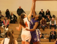 Tigers center Isabella Lacarbonara (left) jumps against Huguenots center Dionna Rogers (right) as the statement-game for White Plains this season gets underway at WPHS, on Thursday, Jan. 8. White Plains lost to New Rochelle, 54-49, but the future looks bright. Albert Coqueran Photo