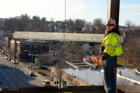 worker 4th floor signed beam | The Examiner News The signed beam is ready to be fitted into place.