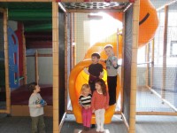 Steven and Jack (standing on the slide) Chloe and Lillian (sitting on the slide) and Blake all play together inside Jack’s Clubhouse. 