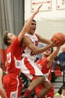 Fox | The Examiner News Fox Lane's Alex Olsen tries to split the defense of Somers' Ryan Grossman and Anthony Maestri in Foxes win over Tuskers last Thursday.