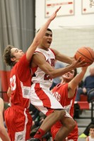 Fox Lane's Alex Olsen tries to split the defense of Somers' Ryan Grossman and Anthony Maestri in Foxes win over Tuskers last Thursday.