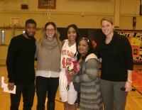 : Brittany Johnson played two years of varsity basketball for the Lady Tigers. Johnson said, “It is great to make the playoffs. It was better this season, we did really well, and we just participated well as a team.” Johnson (center) celebrated Senior Day with [l-r] Assistant Coaches Spencer Smith and Amy Ferraro, Jocelyn’s mother Sheryl Johnson and Head Coach Tara Flaherty, before the Tigers beat Mamaroneck High School for their 10th victory this season. 