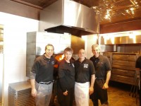 Co-owners Steve (far right) and Lenny Sauro (far left), along with managers Nick DeMamo and Laura Moreno stand in front of a burning stove that has been churning out pizza pies for a week now.  DAVID PROPPER PHOTO 