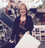 Diane Darby of Absolute Flooring in Yorktown Heights holding the two vinyl tiles selected by The Home Guru and Mrs. Guru for their checkerboard kitchen floor where a “softer, warmer” surface was required for an older floor. Bill Primavera photo 