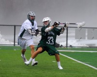Yorktown's Billy Strassman cranks home a goal with Brewster's Luca Riolo bearing down in the Huskers' 18-6 win over the host Bears last Thursday.
