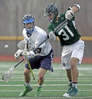 Pleasantville's Jack Drillock pokes the ball away from Putnam Valley's Kyle Bronzo.