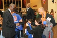 Westchester Knicks Interim Head Coach Craig Hodges (left), signs an autograph for a young fan at the autograph session that followed the Knicks last game of their inaugural season, at the Westchester County Center. Now, the question is, will Hodges return next season to lead the local Knicks. 