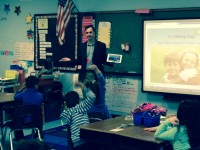 News-O-Matic Editor-in-Chief Russell Kahn works with second graders at George Washington Elementary School to produce a story list for the daily kids newspaper.