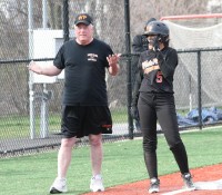 Tigers-2 | The Examiner News Tigers Head Coach Ted O’Donnell (left) seems to be calling for offense to score Dana Jensen (right), after she doubled to leadoff the fourth inning. Jensen was stranded at third base and the Tigers loss, 17-1, to The Ursuline School, in New Rochelle, on Thursday, April 16.