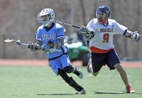 4-28lax3-Robert DiNota, Devon Cummings | The Examiner News Westlake's Robert DiNota moves past Devon Cummings of Byram Hills in last Saturday's game.