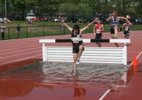 Loucks-3 | The Examiner News White Plains High School Steeplechase runner Adrian Ojeda leaps the barrier and runs through the water obstruction in the Men’s 3000 Meter Steeplechase in the Glenn D. Loucks Games, on Saturday, at WPHS. Ojeda ran a good race, finishing 21st with a time of 10:35.06.