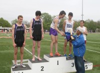 Biff Henderson (right holding trophy), the Stage Manager for The Late Show with David Letterman, presents The Olympian Trophy to 3000 Meter Men’s Steeplechase Champion Jake Gibb (center), who ran the third fastest time in Loucks Games history at 9.16.47, which was also the fastest high-school time in the United States this year. Henderson, a Greenburgh resident, and Letterman will air their last Late Show, on CBS, on Monday, May 20, after 34 years. 