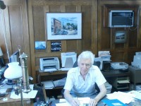 : Barry Hyatt of Air and Marine Travel sits in his 55-year-old office in Brewster.  DAVID PROPPER PHOTO 