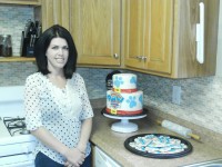 Angela Maass shows off a recent cake she baked and decorated inside her very own kitchen. The Brewster resident has been baking away for six years. DAVID PROPPER PHOTO 