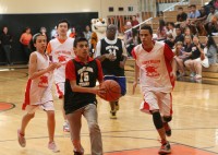 Tigers forward Marc Toribio (#15 center) drives to the hoop and scores two points for the White Plains High School Special Olympics basketball team. However, the Sleepy Hollow Horsemen held on to win the Third Annual Special Olympics Homecoming game, 24-19. Albert Coqueran Photo