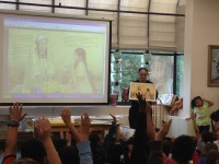 Book illustrator Robert Casilla tells fourth graders at White Plains George Washington Elementary School how images end up in books.