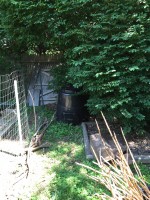 A backyard composting unit provides fertilizer for gardening.