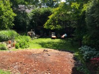 Soil removed from under the former front driveway to make room for the permeable paving layers is being redistributed in the back yard to create a more level space.