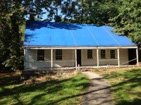 The Elijah Miller House/Washington’s Headquarters in North White Plains, with a blue tarp covering its roof, continues to deteriorate as Westchester County and the Town of North Castle quarrel about how to save the landmark.