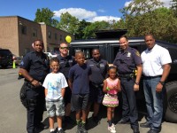 Sebastian, Bryce and Kalani pose with some of their new friends in front of a refurbished military SWAT tank purchased in July by the Greenburgh Police Department during a pot luck fundraiser August 28 to support the Lois Bronz Children’s Center. Pat Casey Photos
