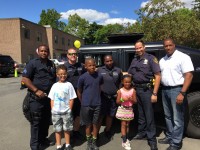Lois Bronz | The Examiner News Sebastian, Bryce and Kalani pose with some of their new friends in front of a refurbished military SWAT tank purchased in July by the Greenburgh Police Department during a pot luck fundraiser August 28 to support the Lois Bronz Children’s Center. Pat Casey Photos