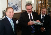 Pleasantville Mayor Peter Scherer signs a decorative plate at the Iron Horse Grill Tuesday with Robert Astorino and Iron Horse Grill owner Andrew Economos to help kick off Hudson Valley Restaurant Week. Arthur Cusano photo 