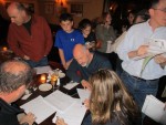 New Castle Supervisor Robert Greenstein, seated, tabulate votes while surrounded by supporters Tuesday night.