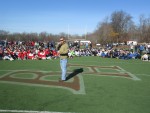 Retired U.S. Army Sgt. Deven Schei speaks to the hundreds of lacrosse players and community members who helped raise more than ,000 for the Wounded Warrior Project at Sunday’s No Man Down Lacrosse Classic at Byram Hills High School.