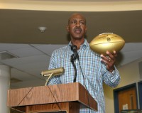 Art Monk, a 1976 graduate of White Plains High School played 16 years in the NFL and won three Super Bowls with the Washington Redskins. Monk displays the NFL Wilson Gold Football that he presented to the Tigers football program on behalf of the NFL Super Bowl High School Honor Roll initiative. 